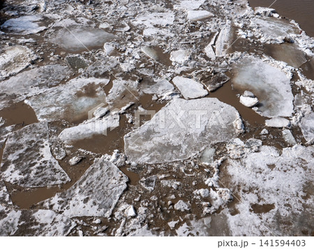 River with floating ice ice drift spring thaw natural landscape water and ice background seasonal change scenery. River with floating ice ice drift spring thaw natural landscape water and ice background seasonal change scenery. 141594403