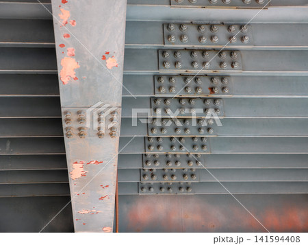 Close up of many metal nuts and bolts on bridge structure industrial engineering detail steel fasteners background. Close up of many metal nuts and bolts on bridge structure industrial engineering detail steel fasteners background. 141594408