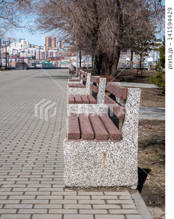 Park benches in urban park outdoor seating recreation public space green area. Park benches in urban park outdoor seating recreation public space green area. 141594429