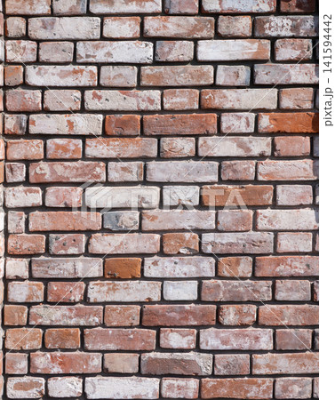 Old red brick wall texture weathered and peeling surface grunge background for design use. Old red brick wall texture weathered and peeling surface grunge background for design use. 141594442