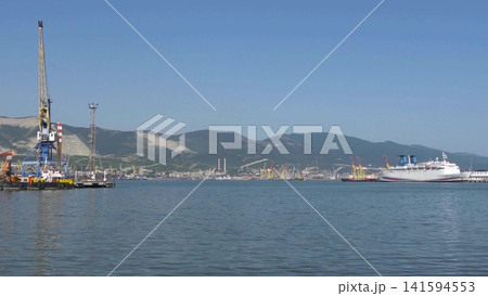 August 22 2025 View of Novorossiysk port Russia with cargo ships and cranes on the coastline. Industrial maritime scene on the Black Sea August 22 2025 View of Novorossiysk port Russia with cargo ships and cranes on the coastline. Industrial maritime scene on the Black Sea 141594553