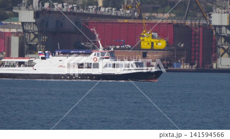 August 12, 2025: White motorboat near the port of Novorossiysk, Russia, with people relaxing on board August 12, 2025: White motorboat near the port of Novorossiysk, Russia, with people relaxing on board 141594566
