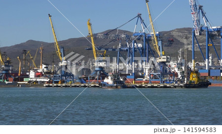 August 22 2025 View of Novorossiysk port Russia with cargo ships and cranes on the coastline. Industrial maritime scene on the Black Sea August 22 2025 View of Novorossiysk port Russia with cargo ships and cranes on the coastline. Industrial maritime scene on the Black Sea 141594583