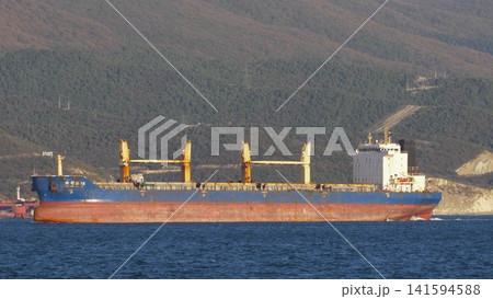 August 24, 2025: Large cargo ship entering the port of Novorossiysk, Russia, on the Black Sea, illustrating maritime transport, industrial shipping and coastal infrastructure August 24, 2025: Large cargo ship entering the port of Novorossiysk, Russia, on the Black Sea, illustrating maritime transport, industrial shipping and coastal infrastructure 141594588