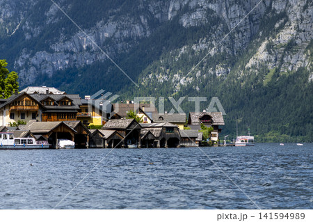 Hallstatt village and scenic lakeside in the Austrian Alps, illustrating European small town charm with classic summer atmosphere. Hallstatt village and scenic lakeside in the Austrian Alps, illustrating European small town charm with classic summer atmosphere. 141594989