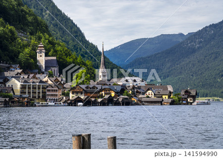 Hallstatt village with its church on the lake in Salzkammergut, Upper Austria, suitable as a calm wallpaper or background. Hallstatt village with its church on the lake in Salzkammergut, Upper Austria, suitable as a calm wallpaper or background. 141594990