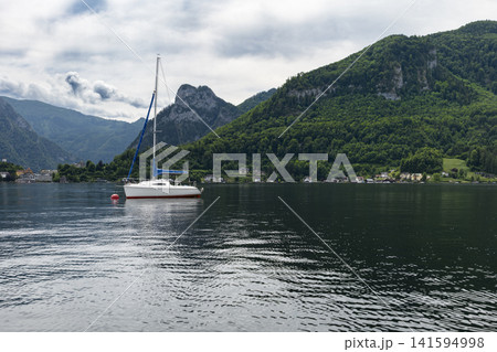 Sailboat on Lake Traunsee in the Salzkammergut, illustrating scenic lake tourism in Austria and classic alpine summer vibe. 141594998