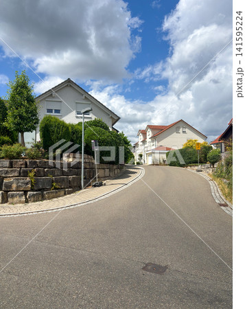 Quiet residential street with modern houses in Steinenbronn village, Baden-Wuerttemberg, Germany Quiet residential street with modern houses in Steinenbronn village, Baden-Wuerttemberg, Germany 141595224