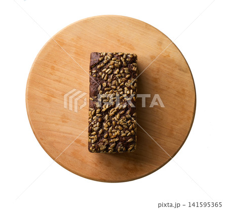 loaf wholemeal rye bread with sunflower seeds on cutting board , top view. isolated on white background. 141595365