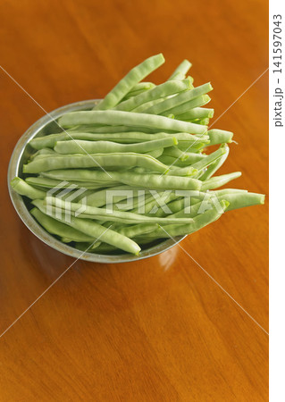Fresh green beans in a stainless steel bowl Fresh green beans in a stainless steel bowl 141597043