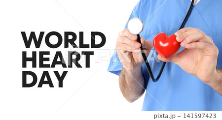 World Heart day. Medical professional holds red heart toy while using stethoscope, PNG 141597423