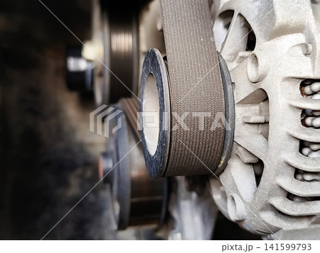 starter motor in a car connected to the drive belt starter motor in a car connected to the drive belt 141599793