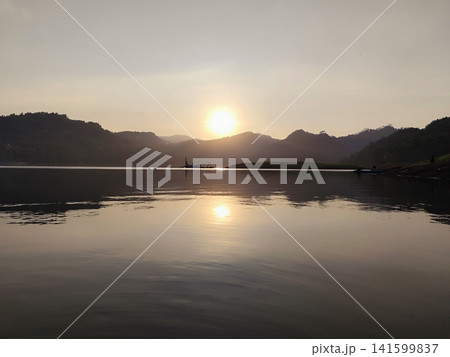 beautiful sunset over a lake in the mountains 141599837