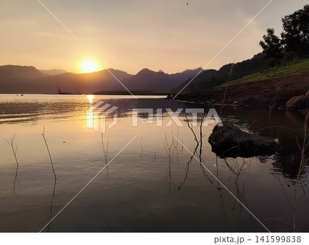 beautiful sunset over a lake in the mountains beautiful sunset over a lake in the mountains 141599838