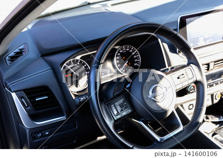 Modern vehicle cockpit showing steering and controls Modern vehicle cockpit showing steering and controls 141600106