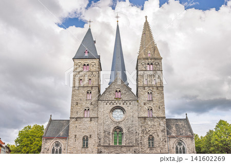 Ghent town in Belgium, Europe. Historical Stone Church with Multiple Spires and Gothic Architecture Against a Cloudy Sky on a Bright Day Ghent town in Belgium, Europe. Historical Stone Church with Multiple Spires and Gothic Architecture Against a Cloudy Sky on a Bright Day 141602269