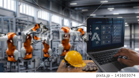 Engineer wearing hard hat and safety glasses uses laptop checklist dashboard in robotic factory, reviewing inspection, safety compliance, quality control, manufacturing verification process. Engineer wearing hard hat and safety glasses uses laptop checklist dashboard in robotic factory, reviewing inspection, safety compliance, quality control, manufacturing verification process. 141603074