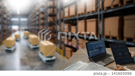 Warehouse robots transport boxes through storage aisles while a laptop and tablet display operational dashboards, supporting logistics automation, inventory monitoring, and warehouse management. Warehouse robots transport boxes through storage aisles while a laptop and tablet display operational dashboards, supporting logistics automation, inventory monitoring, and warehouse management. 141603098