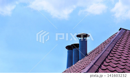 Chimney on the tiles roof.Ventilation pipes Chimney on the tiles roof.Ventilation pipes 141603232