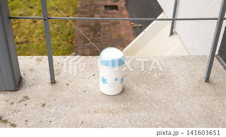 Small decorative trash bin on balcony with blue floral design Small decorative trash bin on balcony with blue floral design 141603651