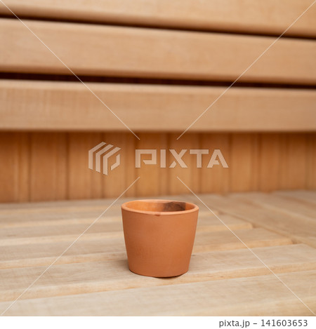 Empty terracotta plant pot on wooden background in minimalist setting Empty terracotta plant pot on wooden background in minimalist setting 141603653