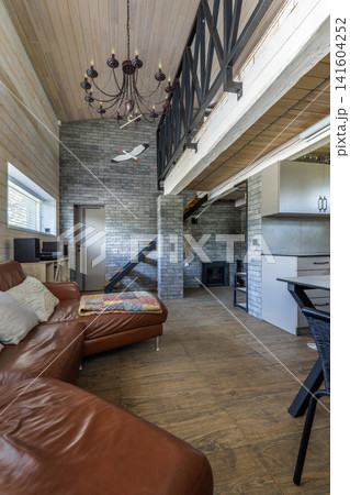 Modern Country House Interior with Leather Sofa and Chandelier Modern Country House Interior with Leather Sofa and Chandelier 141604252
