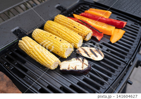Grilled corn and vegetables on barbecue grill: corn, bell peppers, eggplant slices on bbq 141604627