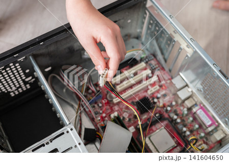 Caucasian child exploring computer hardware and assembling motherboard components Caucasian child exploring computer hardware and assembling motherboard components 141604650