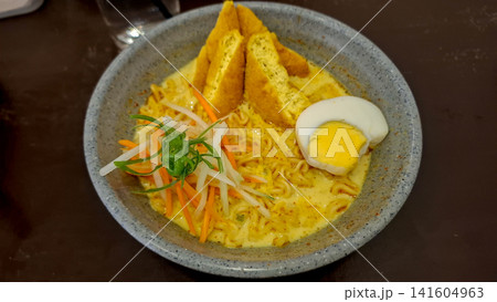 Indonesian Curry Noodle Soup Laksa with Tofu Egg and Shredded Vegetables Indonesian Curry Noodle Soup Laksa with Tofu Egg and Shredded Vegetables 141604963