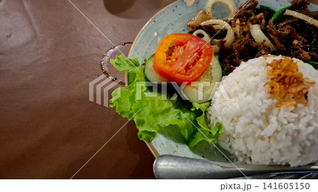 Close Up View of Indonesian Sliced Beef Dish with Rice and Salad Close Up View of Indonesian Sliced Beef Dish with Rice and Salad 141605150