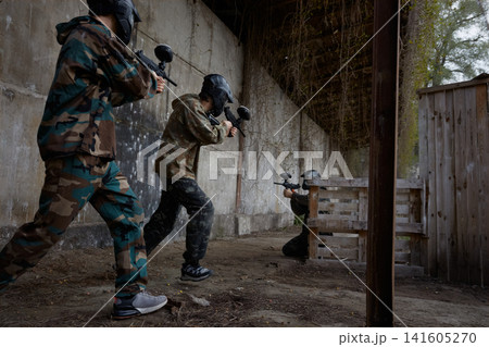 Two soldiers point their weapons at a third soldier, ready to fire Two soldiers point their weapons at a third soldier, ready to fire 141605270