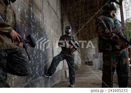 An armed group of several soldiers resting from practice with weapons on a training field An armed group of several soldiers resting from practice with weapons on a training field 141605272