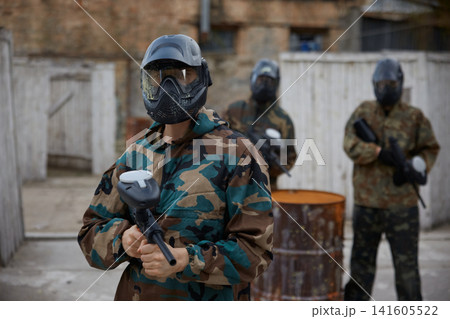 An armed group of several soldiers practice with weapons on a training field An armed group of several soldiers practice with weapons on a training field 141605522