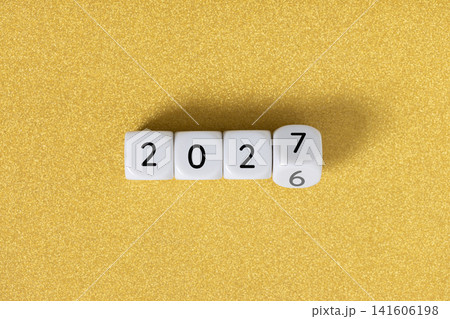 Year 2026 changing to 2027 on dice, glitter festive golden background. New year change concept Year 2026 changing to 2027 on dice, glitter festive golden background. New year change concept 141606198