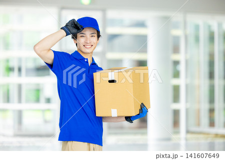 荷物を届ける宅急便の男性ドライバー 荷物を届ける宅急便の男性ドライバー 141607649