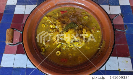 Traditional Moroccan Chicken Tagine with Green Olives and Bay Leaf Traditional Moroccan Chicken Tagine with Green Olives and Bay Leaf 141609384