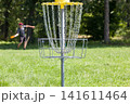 Man throwing frisbee playing disc golf 141611464