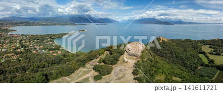 Drone panorama of Rocca di Manerba, San Biagio Island and Lake Garda in summer Drone panorama of Rocca di Manerba, San Biagio Island and Lake Garda in summer 141611721