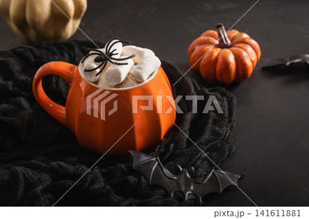 Halloween drink with marshmallows spiders pumpkins and bat decoration Halloween drink with marshmallows spiders pumpkins and bat decoration 141611881
