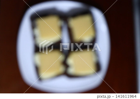 Four cheese sandwiches on a white plate. Four cheese sandwiches on a white plate. 141611964