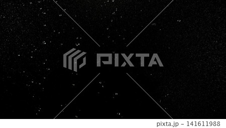 High speed close up of falling rain droplets isolated on a black background creating a realistic weather VFX overlay perfect for cinematic compositing visual effects motion graphics and atmospheric 141611988