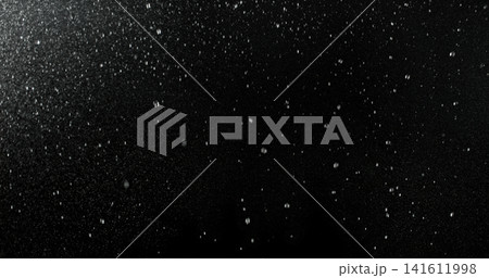 High speed close up of falling rain droplets isolated on a black background creating a realistic weather VFX overlay perfect for cinematic compositing visual effects motion graphics and atmospheric 141611998