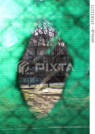 Close-up of a hole in a fence. Close-up of a hole in a fence. 141612271