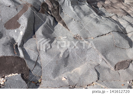 A warped old roofing material on the roof. A warped old roofing material on the roof. 141612720