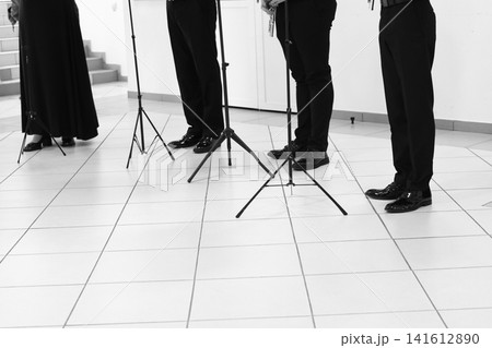 Male legs in black pants and black shoes. 141612890