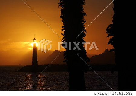 Seascape at sunshine. Lighthouse and sailings on the coast. Seaside town of Turgutreis and spectacular sunshine 141613588