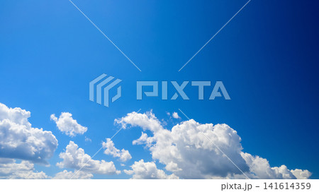 bizarre white clouds scattered across the rich blue summer sky bizarre white clouds scattered across the rich blue summer sky 141614359