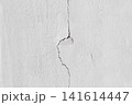 background texture of a cracked white concrete wall with damaged cement surface 141614447