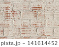 background texture of a distressed white painted red brick wall texture with weathered masonry surface 141614452