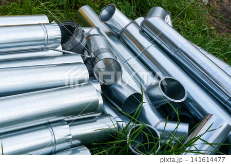 Stack of Galvanized Rainwater Gutters and Downpipe Components Ready for Roof Drainage Installation Site Stack of Galvanized Rainwater Gutters and Downpipe Components Ready for Roof Drainage Installation Site 141614477